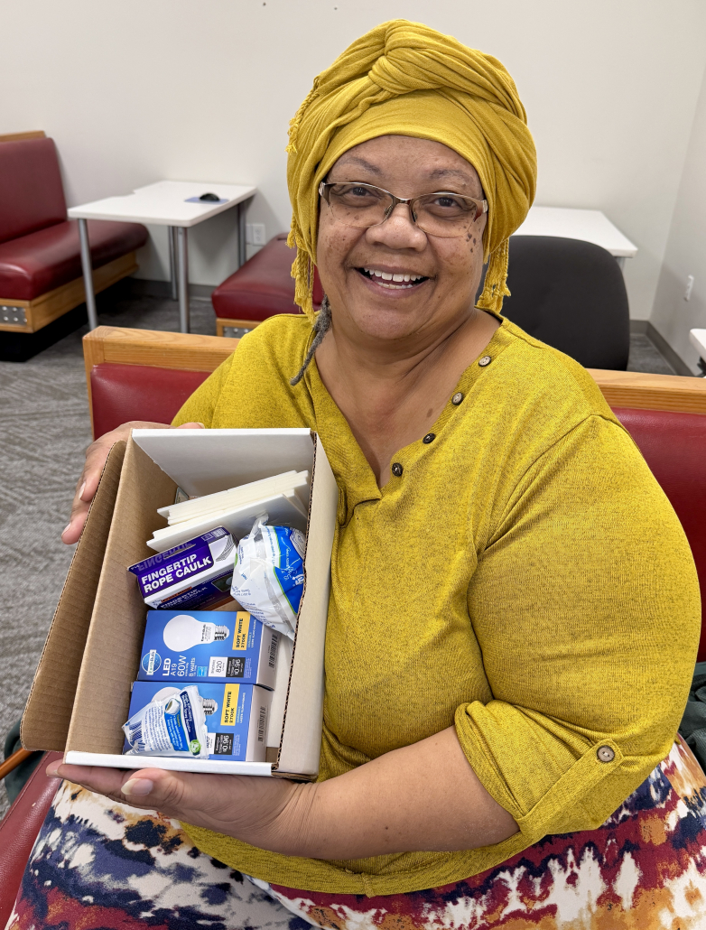 Denise Hart holds an energy efficiency kit provided by Metropolitan Energy Center's Healthy Homes program.